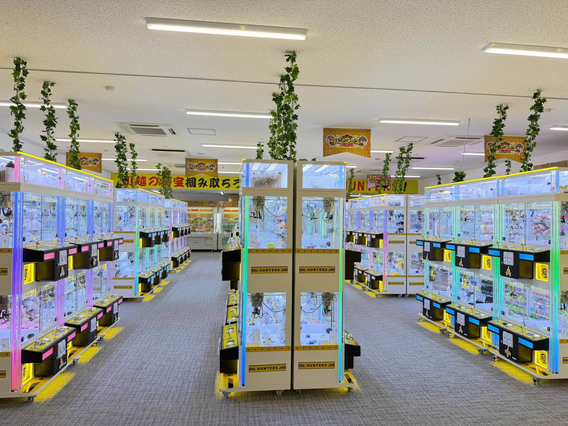 Commercial arcade interior featuring multiple Gen 3 mini claw machine zones with organized layout
