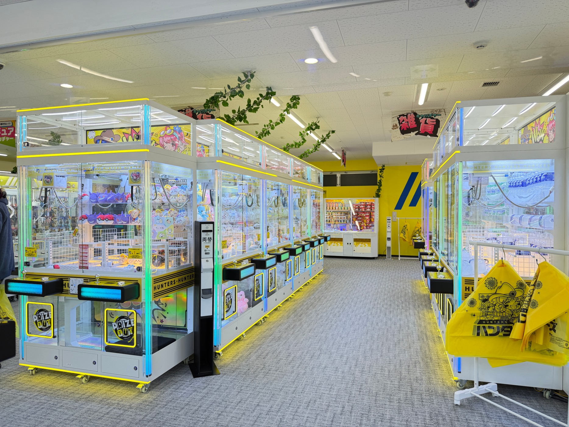 Dual player claw machine installed in an arcade store layout with LED lighting and commercial plush prize display