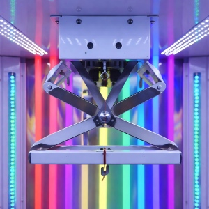 Gen 12 scissor claw machine cutting mechanism close-up with reinforced metal scissor structure and RGB LED lighting