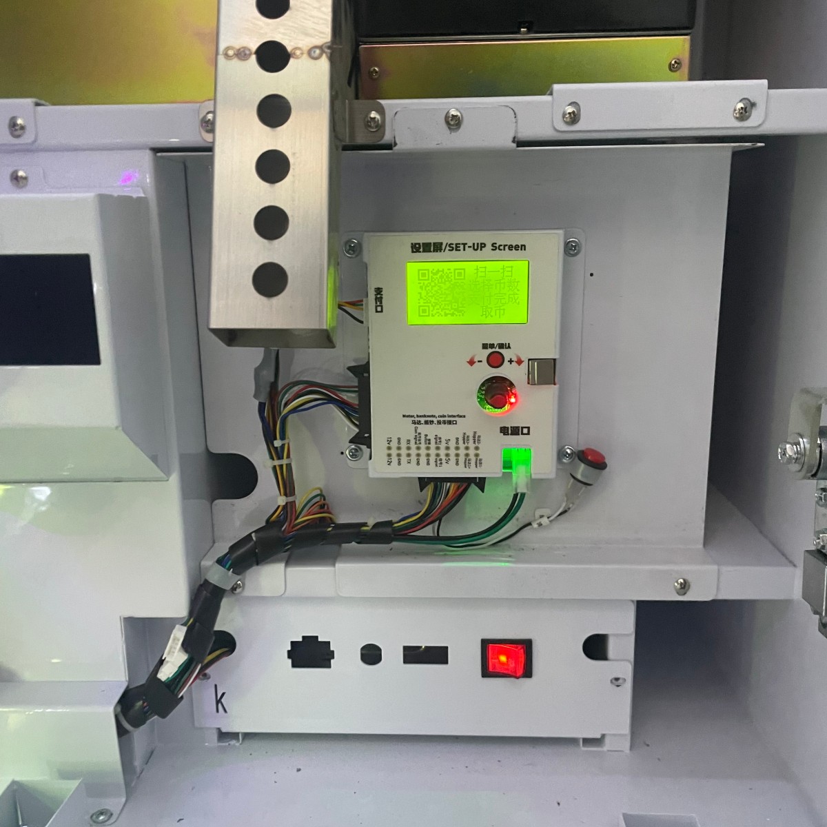Internal structure of bar counter coin changer machine showing control board wiring and payment system