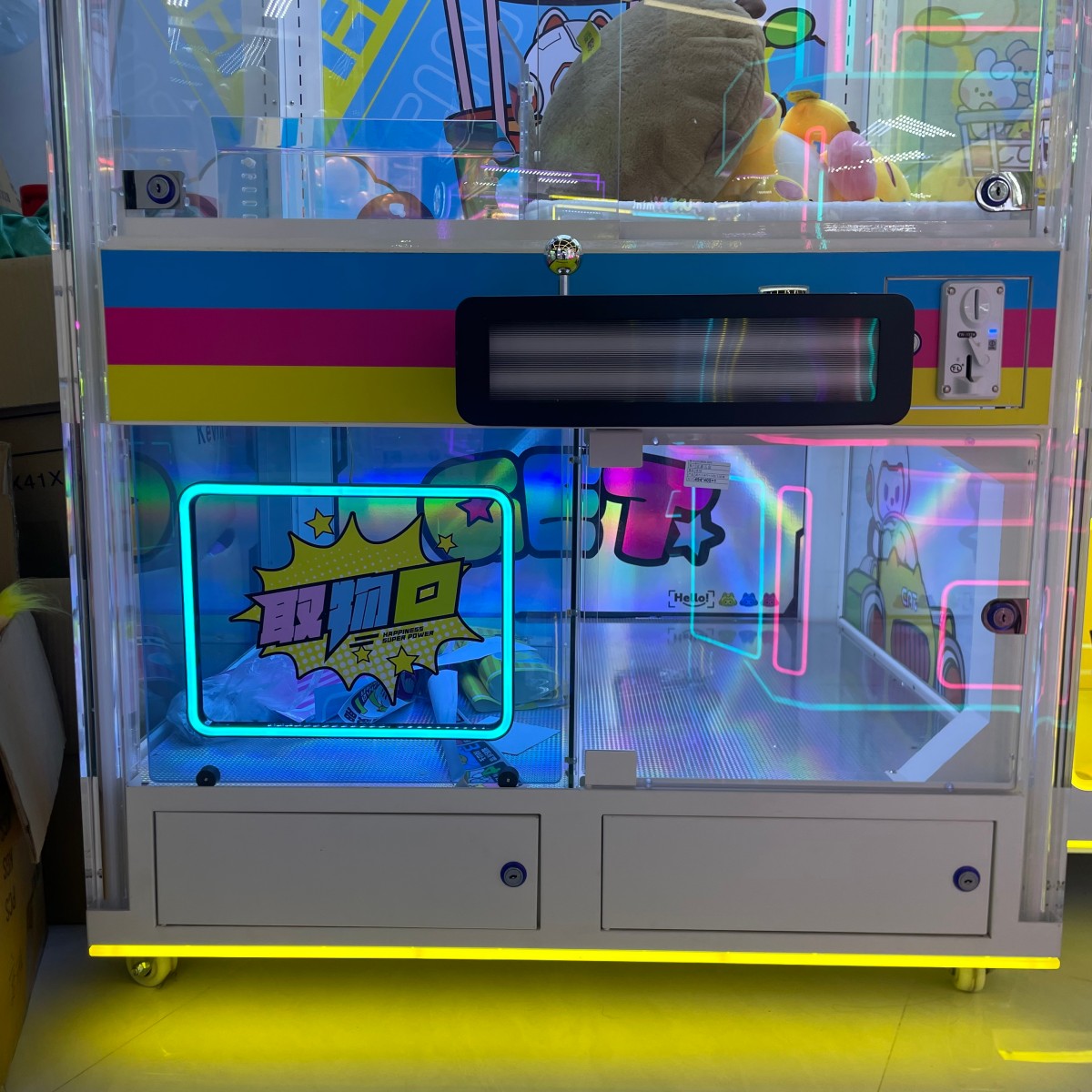 Lower cabinet of full transparent jumbo claw machine with acrylic enclosure and storage access