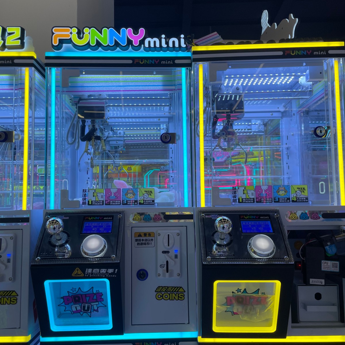 Personal mini claw machines displayed in pairs with LED lighting for single-player entertainment