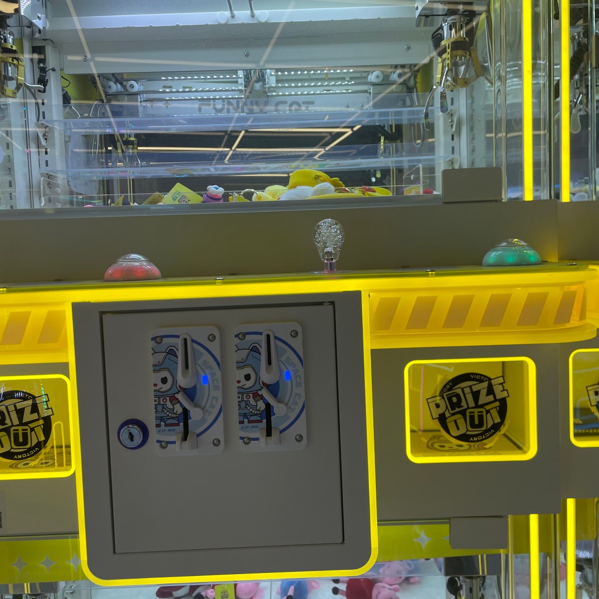 Prize exit of Gen 3 mini claw machine showing successful grab of small plush toy